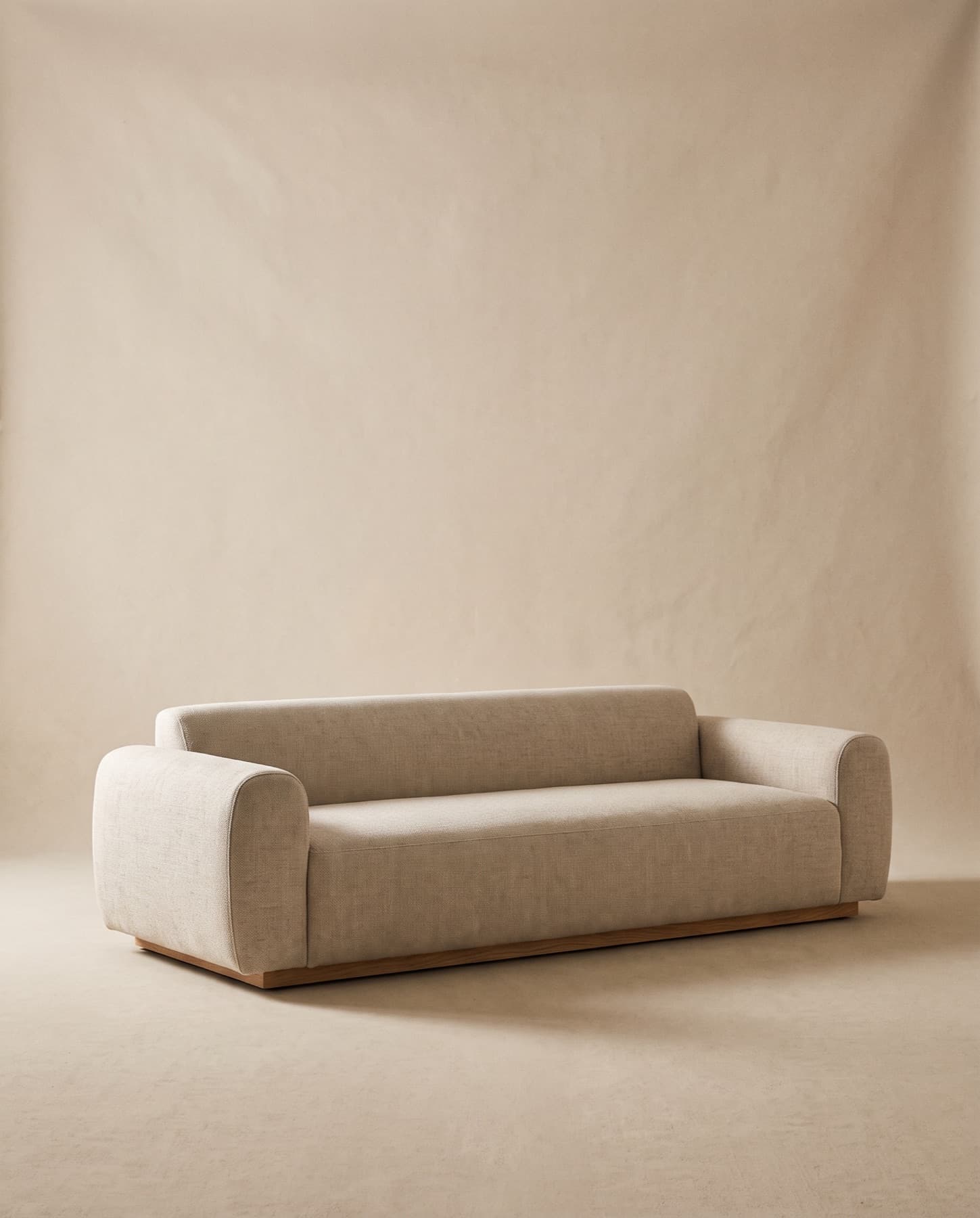 Marlow sofa in oatmeal linen-wool with rounded arms on a recessed plinth