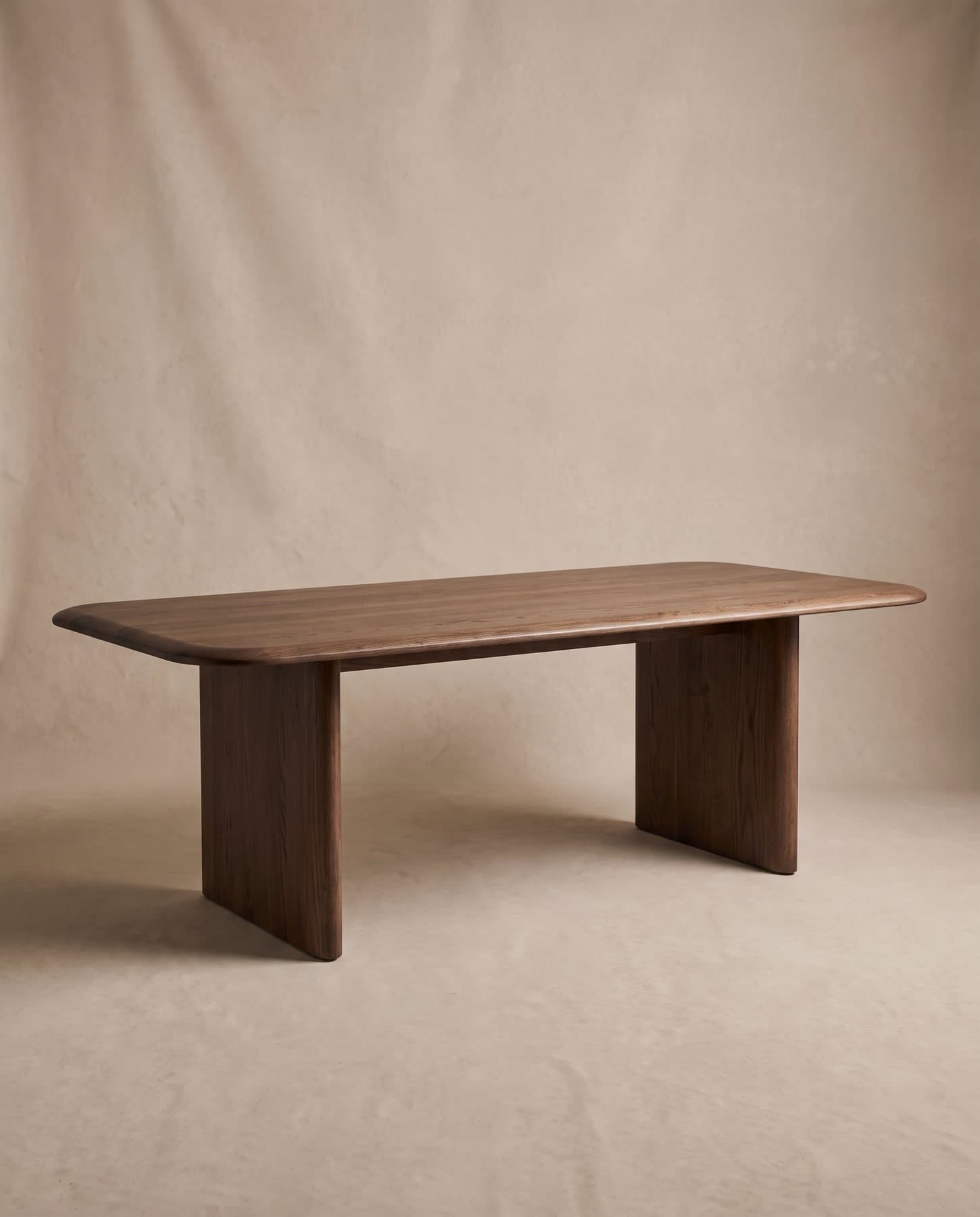 Forum meeting table in smoked oak with radiused corners on two solid panel legs