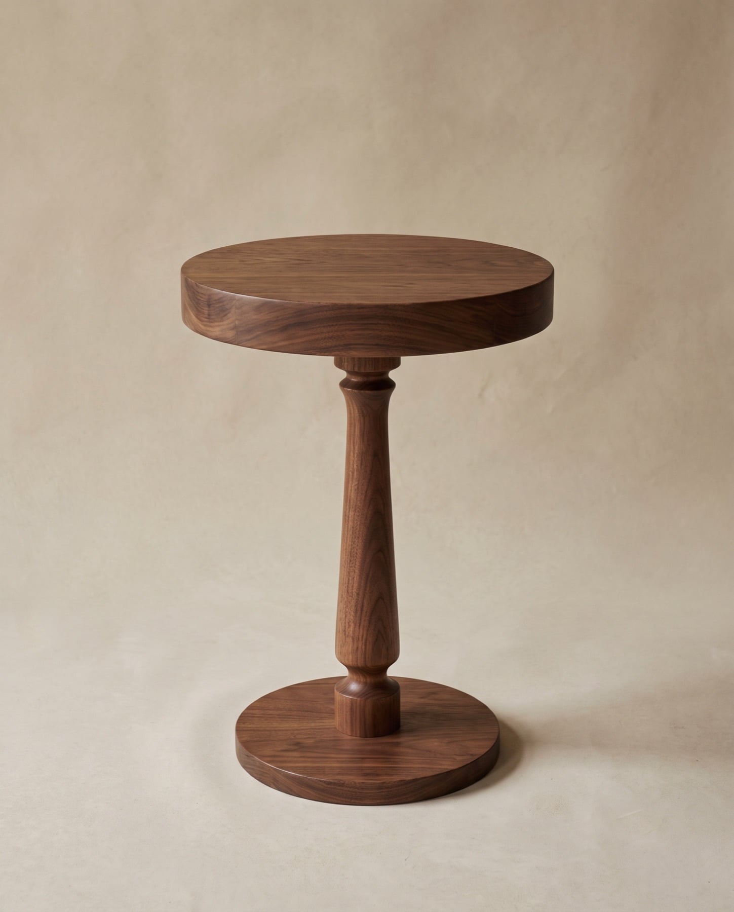 Rove side table turned in black walnut, with a round top on a shaped column and disc base